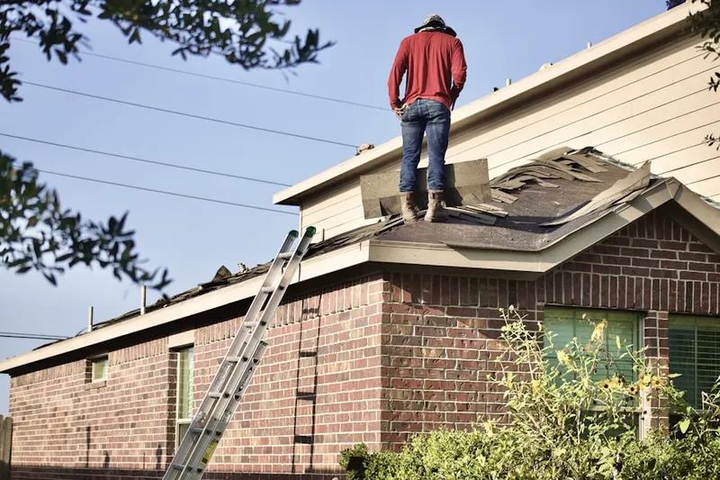 Professional roofer working on a residential roof in Canfield